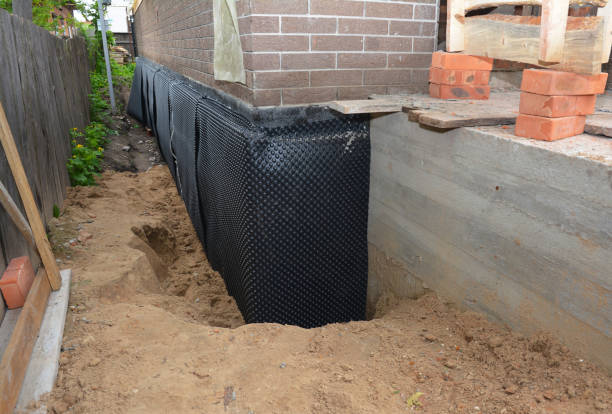 Happy homeowners after waterproofing job in Cambria